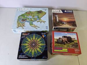 lot 244 image: (4) 600 and 1000 Piece Puzzles